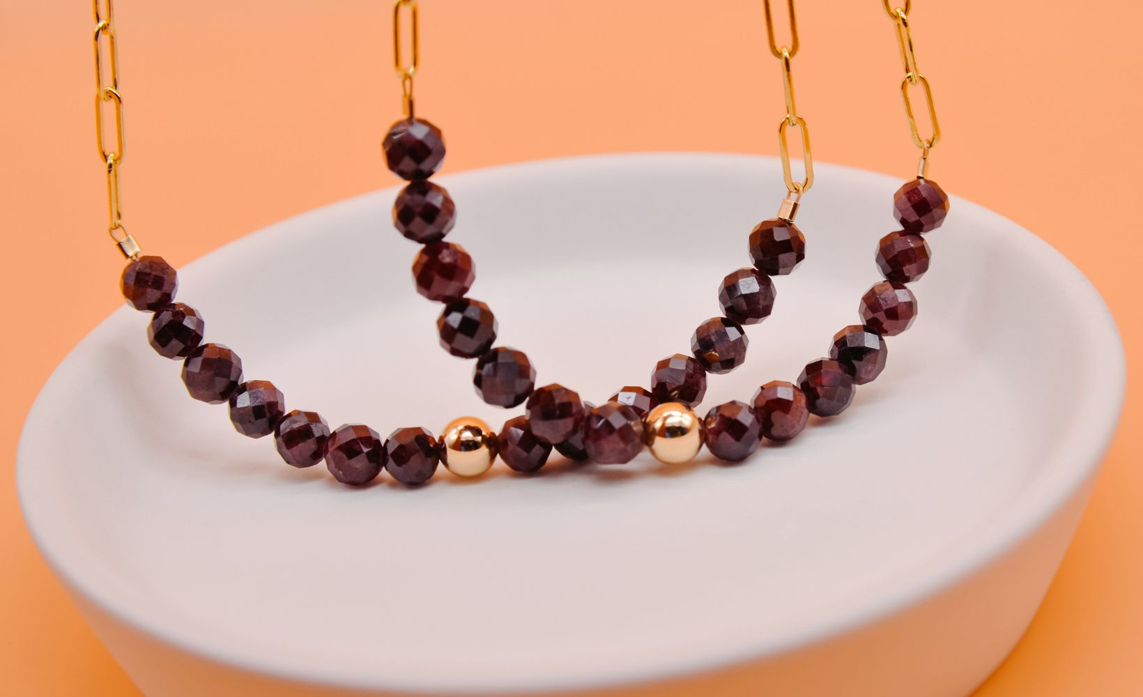 January birthstone garnet necklaces hanging on 14k gold filled chain with gold centerpiece beads by Emerald Sun Creations