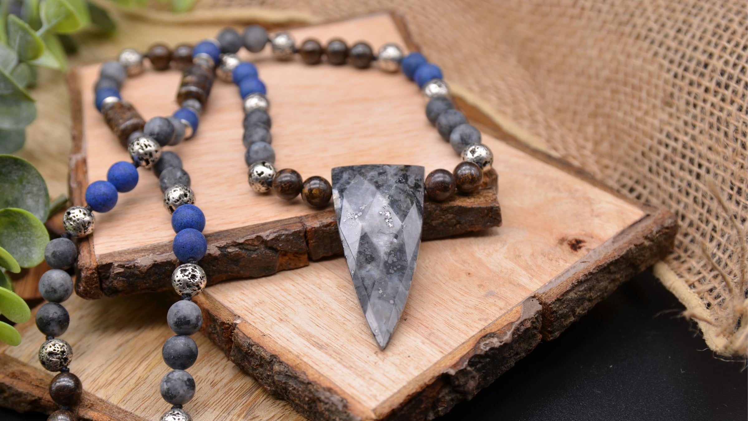 Image of a necklace with shield shaped pendant created from larvikite gemstone and variety of other gemstone beads that include lapis lazuli, larvikite, bronzite, and lava stone. Included in our new mens collection. Makes great gifts for Dad on Father's Day | Emerald Sun Creations - Natural Gemstone Jewelry